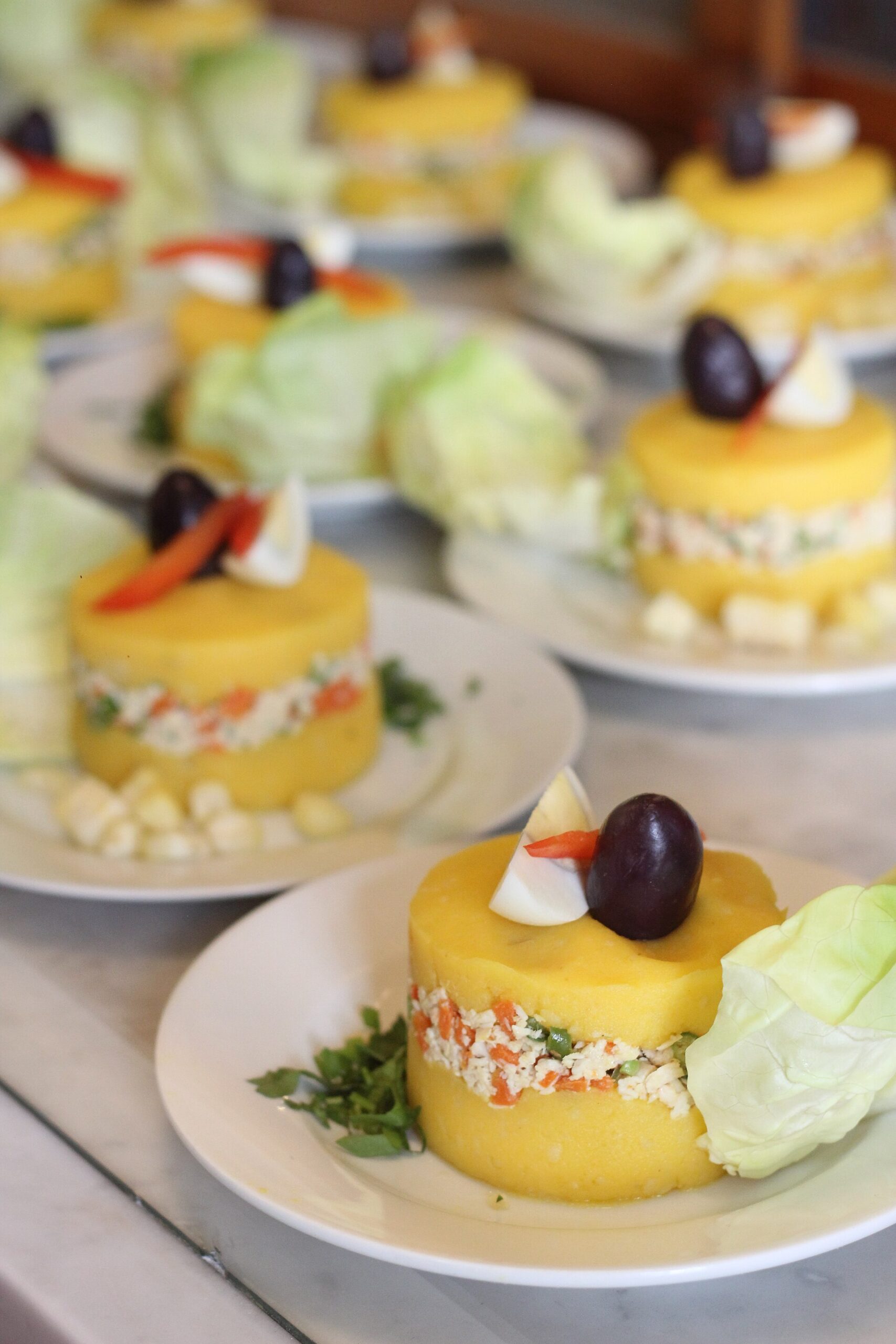 Layered Peruvian causa rellena made with yellow potato