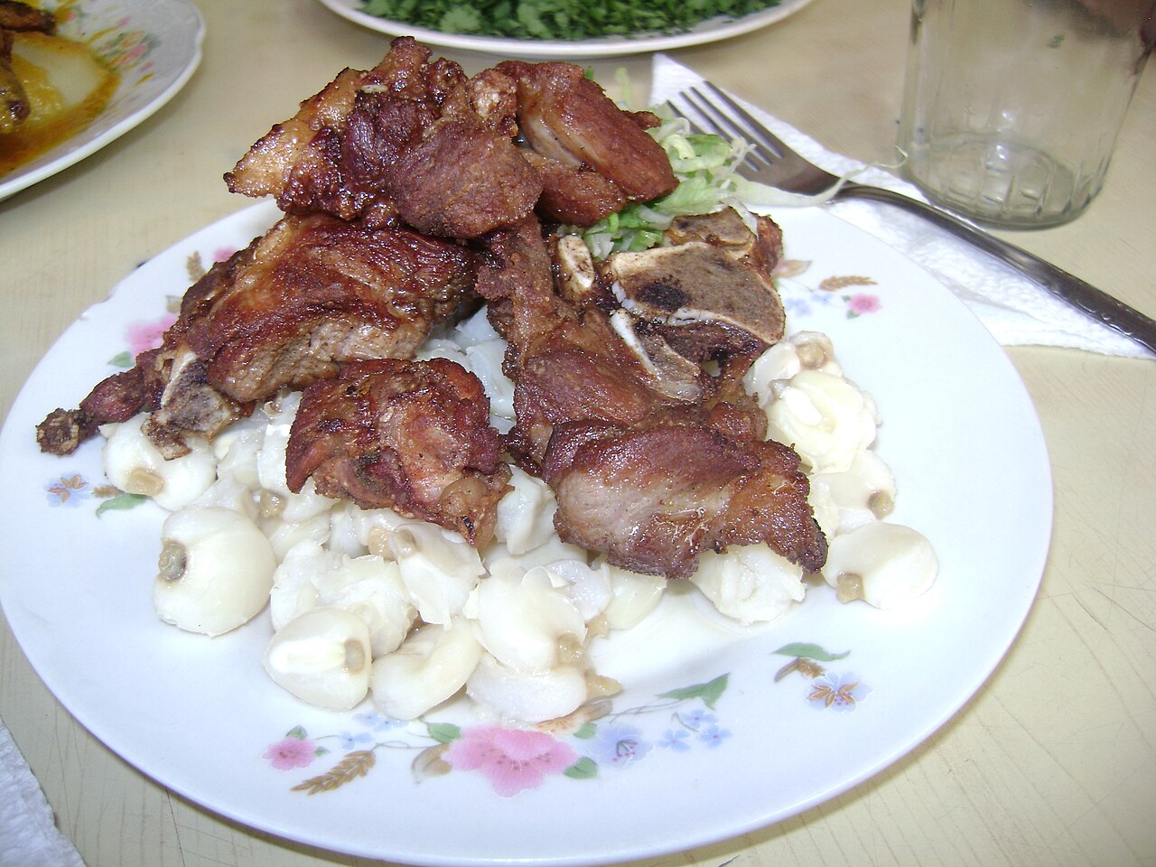 Peruvian pork chicharrón served with mote
