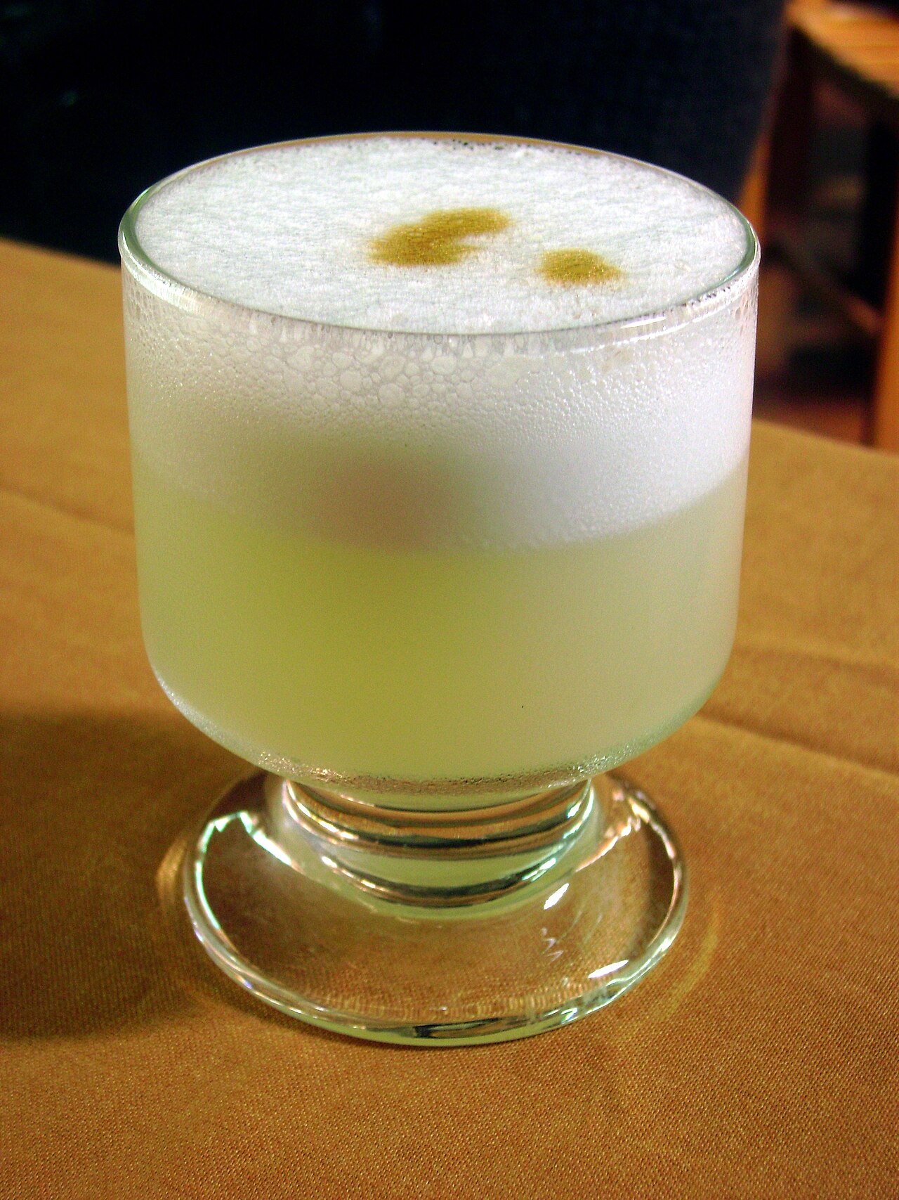 A Peruvian pisco sour cocktail with foam and bitters